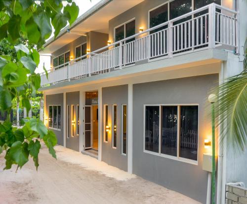 a building with a balcony on top of it at Casaparadiso - Beach View in Ukulhas