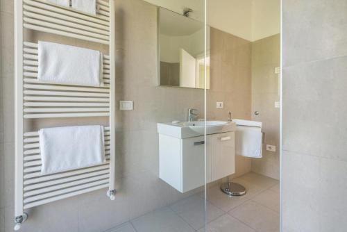 a bathroom with a sink and a mirror at Geranio-Buganville-Viola in Arco