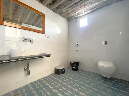 a bathroom with a toilet and a sink at Raj Safari Resort in Sām