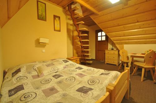 a bedroom with a bed and a desk in a cabin at Willa Marysieńka in Zakopane