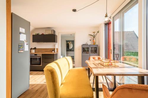 a kitchen and dining room with a table and chairs at Seekind in Kressbronn am Bodensee
