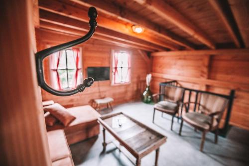 a living room with a couch and a table and chairs at CRASH'NSTAY - The Silo Bungalow in Sprang-Capelle