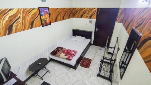an overhead view of a room with a bed and a tv at HOTEL HERITAGE in Chittagong