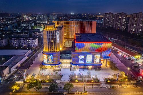two buildings in a city at night at Atour Hotel Shanghai Songjiang Sports Center in Shanghai