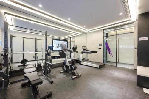 a gym with treadmills and machines in a room at Atour Hotel Shanghai Songjiang Sports Center in Shanghai