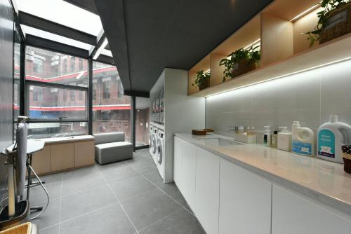 a kitchen with white cabinets and a large window at Atour X Hotel Zhongshan Road Shenyang Station in Shenyang