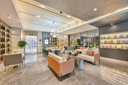 a lobby of a store with couches and tables at Atour Hotel Shanghai Songjiang Sports Center in Shanghai