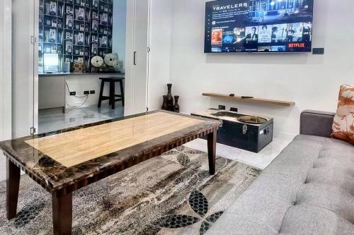 a living room with a table and a couch at Beautiful New home in Throsby with 5 Bedrooms in Harrison