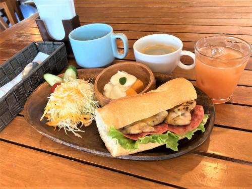 a plate of food with a sandwich and a drink at Ocean Resort PMC in Onna