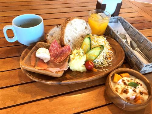 a plate of food with bread and a cup of coffee at Ocean Resort PMC in Onna