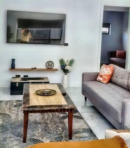 a living room with a couch and a coffee table at Beautiful New home in Throsby with 5 Bedrooms in Harrison