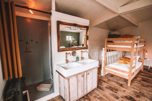 a bathroom with a sink and a bunk bed at CRASH'NSTAY - 't Silo Huis in Sprang-Capelle