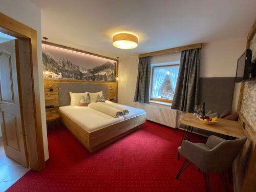 a hotel room with a bed and a window at Hotel Jägerhof in Kaunertal