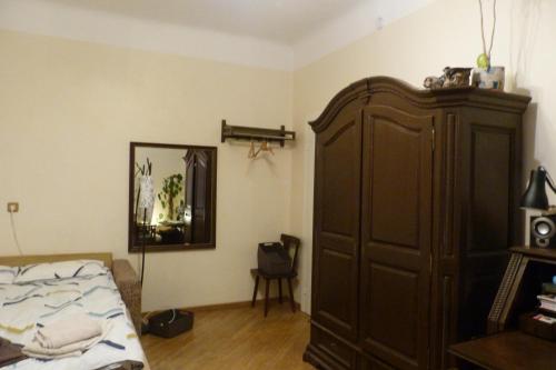 a bedroom with a bed and a large brown cabinet at Accommodation in the historical center of Riga in Riga