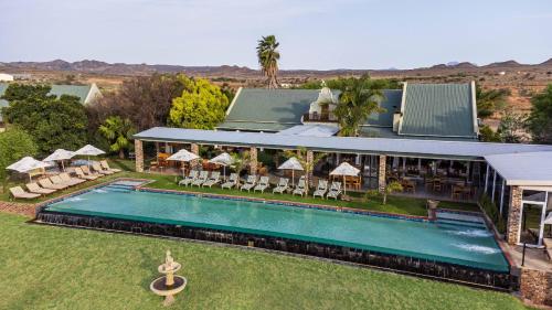 an aerial view of a house with a swimming pool at Mooiplaas Guesthouse in Oudtshoorn