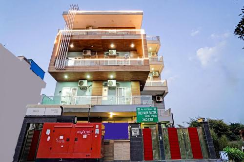 a tall building with red doors and a street sign at The Palm Suites - Medicity in Gurgaon