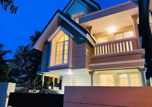 a large house at night with its lights on at The Oval House, Kochi - Approved by Kerala Tourism - Exclusively for Families in Cochin