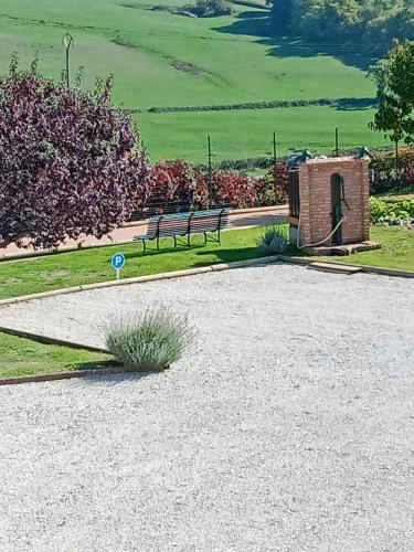 a couple of benches in a park with a field at L OLIVIER DE ST LEGER in Château