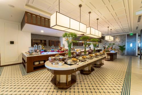 a buffet line in a large room with many food at Potique Hotel in Nha Trang