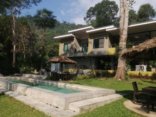 a house with a swimming pool in front of it at Lazy Republique in Ko Chang