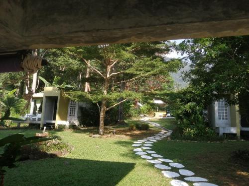 a garden with a path leading to a house at Lazy Republique in Ko Chang