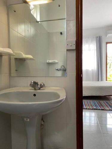 a bathroom with a sink and a mirror at Maison Jade Montchoisy in Mont Choisy