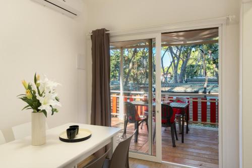 a kitchen with a sliding glass door leading to a patio at Camping Il Capannino Glamping Village in Marina di Bibbona