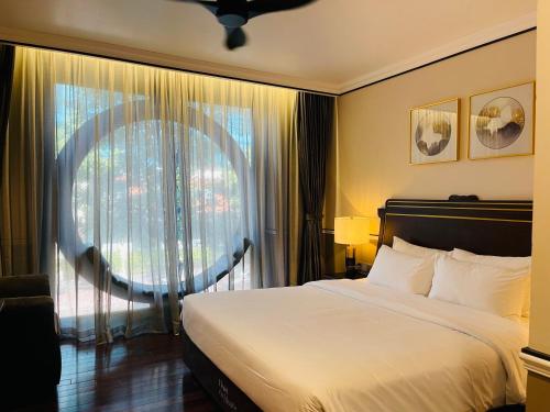 a bedroom with a large bed and a large window at Hotel du Monde Art in Hanoi