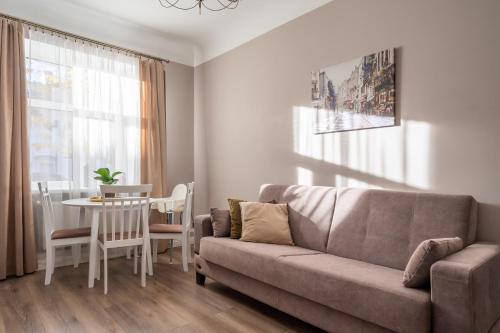 a living room with a couch and a table at Charming Latvian classic style apartment in Rīga