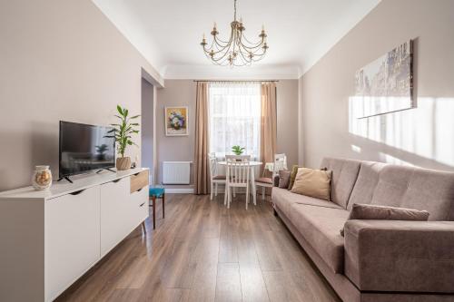 a living room with a couch and a table at Charming Latvian classic style apartment in Rīga
