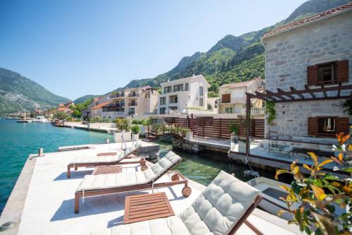 a group of buildings on a body of water at Waterfront Villa in Muo in Kotor