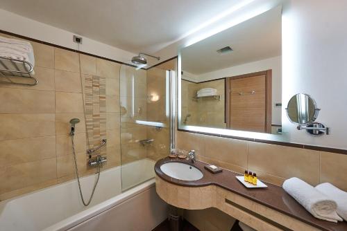 a bathroom with a sink and a shower at Hotel Astoria in Biella
