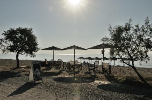 a group of chairs and umbrellas on a beach at Land of Gods in Gythio