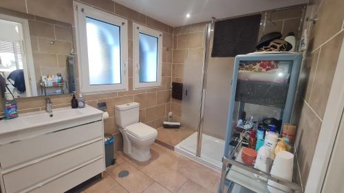 a bathroom with a toilet and a sink and a shower at 240 Front line beach La Cala in La Cala de Mijas