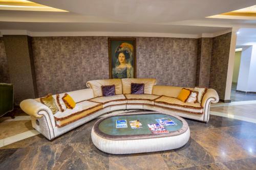 a living room with a couch and a table at Azka Hotel in Bodrum City