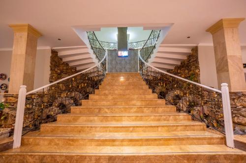 a staircase in a house with wooden floors at Azka Hotel in Bodrum City