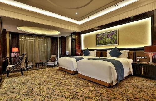a large hotel room with two beds and avisor at Howard Johnson Agile Plaza Chengdu in Chengdu