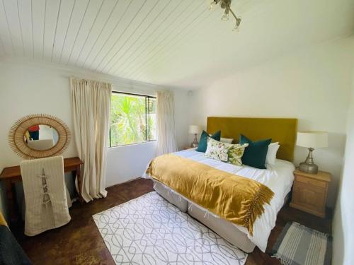 a bedroom with a bed and a window at Caversham Woods in Lidgetton