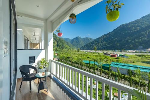 a balcony with a view of the mountains at Zostel Plus Rishikesh, Mohanchatti in Rishīkesh