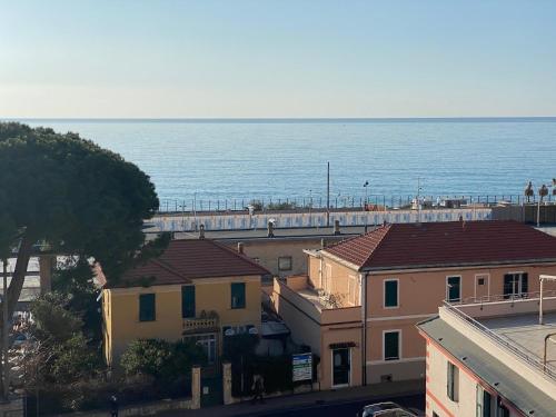 a view of the ocean from a city with buildings at SOLUZIONE CASA Pietra Ligure SEA VIEW in Pietra Ligure