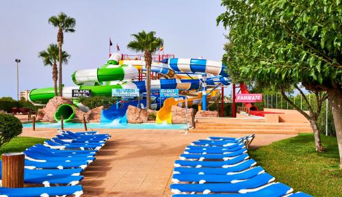 a water park with a water slide in the background at Globales Los Delfines in Cala en Blanes