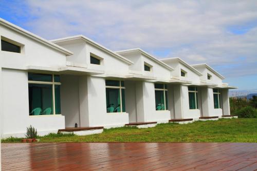 a large white building with a wooden floor at Meet Canaan in Xikou