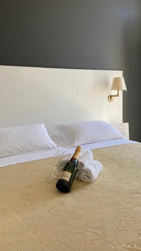a bottle of champagne sitting on top of a bed at Albergo Belsoggiorno in Sanremo