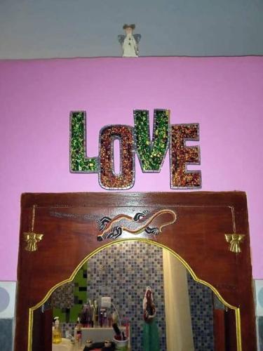 a wooden door with the word love on top of it at Kubu Pilatus – Family House Lombok in Tjakranegara