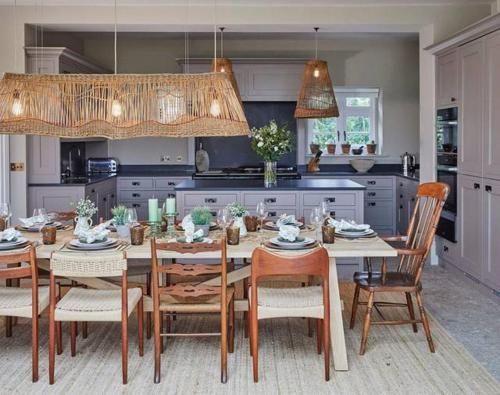 a kitchen with a table and chairs in a kitchen at The Lakes By YOO in Lechlade