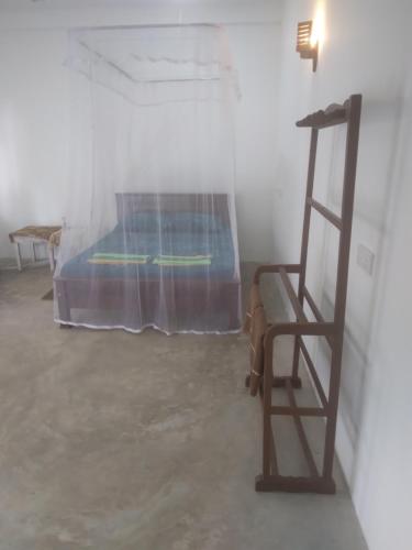 a room with a bed and a wooden ladder at SunRay Rest - Beach View Homestay in Mirissa