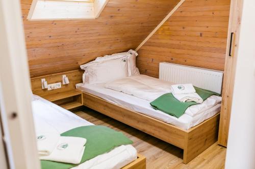 a small room with two beds in a cabin at Chalet Liza & Rozi in Zgornja Ložnica