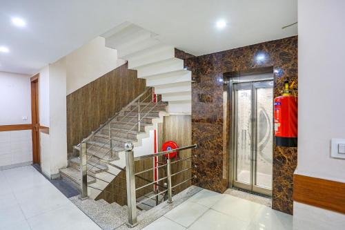 a staircase in a house with a fire extinguisher at FabHotel Frolic in Haridwār