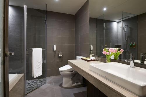 a bathroom with a sink and a toilet and a shower at SOL Hotel in Hsinchu City