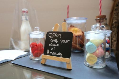 a table with jars of food and a sign on it at Cèdre Beaune, A Beauvallon Hotel & Spa in Beaune